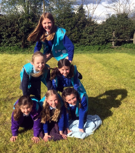 Human pyramid, outdoors at Cirencester after school club.